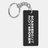 Keychainの傷つけられていたが、壊されなかった黒 キーホルダー (正面左)