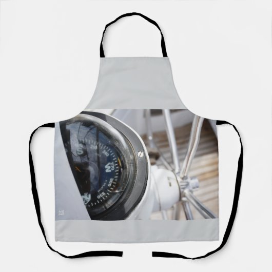 Kompas dat de richting geeft aan een avontuur. エプロン (正面)