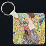 Lady with Fan by Gustav Klimt, Vintage Japonism キーホルダー<br><div class="desc">Lady with Fan (1918) by Gustav Klimt is a vintage Victorian Era Symbolism fine art portrait painting. A beautiful brunette woman holding an oriental fan. The golden floral Japanese themed background is full of blooming exotic flowers, peacocks and other birds with outstretched wings. About the artist: Gustav Klimt (1862-1918) was...</div>
