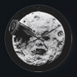 Le Voyage dans la Lune (A Trip to the Moon) Melies ラージ壁時計<br><div class="desc">Man in the moon wall clock using the classic image from  Georges Méliès Le Voyage dans la Lune (A Trip to the Moon). Inspired by Jules Verne's  From the Earth to the Moon,  the short silent film became when of early cinema's most iconic films. This clock omits numerals.</div>