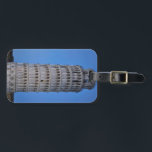 Leaning Tower at Dusk ラゲッジタグ<br><div class="desc">This captivating photograph showcases the iconic Leaning Tower of Pisa standing elegantly against a deep blue twilight sky in Pisa. The historic marble tower, famous for its unmistakable tilt, is beautifully illuminated, highlighting its intricate Romanesque arches and layered columns. The soft evening light creates a striking contrast between the glowing...</div>