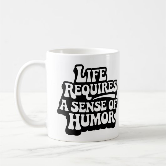 "Life Requires A Sense Of Humor" コーヒーマグカップ (左)