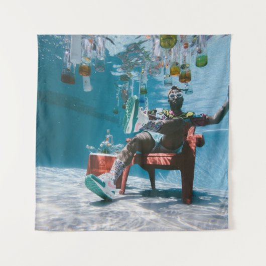 Man sitting on chair underwater with floating bott タペストリー (正面)