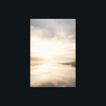 Misty Lake Sunrise Golden Reflection キャンバスプリント<br><div class="desc">Soft golden sunlight pierces through thick morning mist over a calm lake, creating a luminous path of reflection across the water. Tall reeds line the shore while distant trees fade into the haze, and the sky blends warm peach and rose tones into pale blue-gray. The composition radiates profound stillness, gentle...</div>