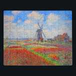 Monet Tulips Windmill ジグソーパズル<br><div class="desc">Puzzle featuring Claude Monet’s flower and windmill painting. Beautiful and colorful fields of red,  pink,  and yellow tulips next to a windmill and house in Holland. A great Monet gift for fans of impressionism and French art.</div>