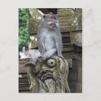 Monkey sitting at a statue in Bali ポストカード