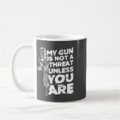 My Gun Is Not A Threat Unless You Are (on Back) コーヒーマグカップ (左)