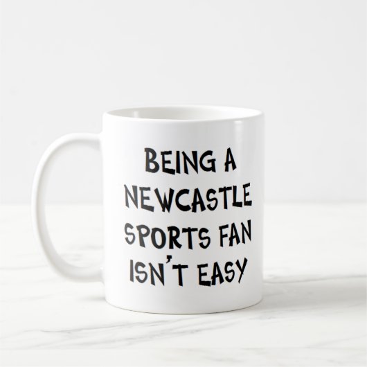 newcastle sports fan, being コーヒーマグカップ (左)