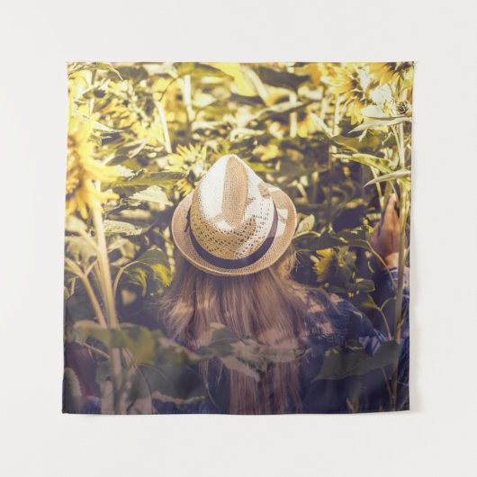 Person wearing white hat beside sunflower fields タペストリー (正面)