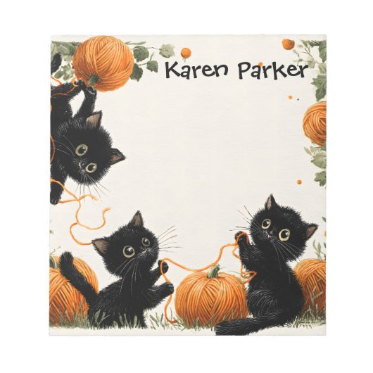  Playful Black Cat with Pumpkin-Inspired Orange ノートパッド (正面)