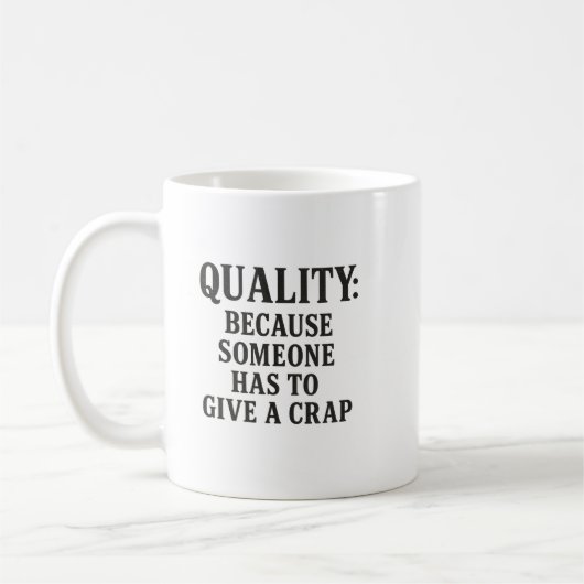 Quality: Because Someone has to... コーヒーマグカップ (左)