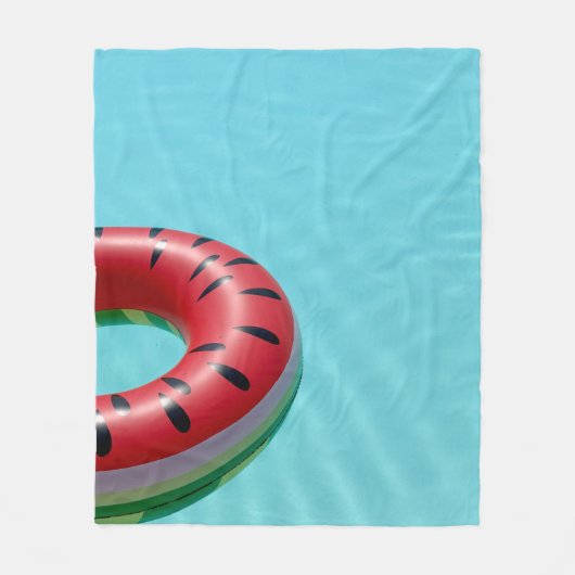 Red and green lifebuoy on swimming pool フリースブランケット (正面)