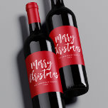 Red and White Brush Script Merry Christmas ワインラベル<br><div class="desc">Festive holiday wine labels featuring "Merry Christmas" displayed in white brush script lettering with a red background. Personalize the Merry Christmas wine labels with your family name and the year displayed in white lettering.</div>