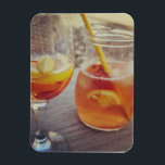 Sangria and Sunshine マグネット<br><div class="desc">This image shows a refreshing glass and pitcher of citrus sangria, perfect for a warm day. The fresh slices of lemon and orange add bright colour and hint of natural sweetness. One glass sits ready to enjoy while sangria is being poured from a small glass pitcher beside it, perfect for...</div>