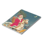 Santa Claus on a wooden horse ノートパッド (回転)
