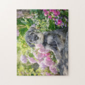 Standard Schnauzer puppy in a flowering garden ジグソーパズル (縦)