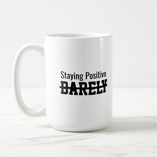 Staying positive barely コーヒーマグカップ (左)