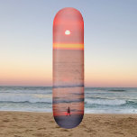 Strolling Through Golden Orange Sunset Skateboard スケートボード<br><div class="desc">This skateboard features an image of a person walking through the golden pink and orange rays of the sunset. The colorful rays create an orb that silhouettes the walker.</div>