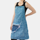 Textured denim background. Torn hole in the fabric エプロン (インサイチュ)