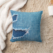 Textured denim background. Torn hole in the fabric クッション (ブランケット)