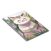 This is an adorable kitten resting on the plants ノートブック (右側)