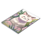 This is an adorable kitten resting on the plants ノートブック (左側)