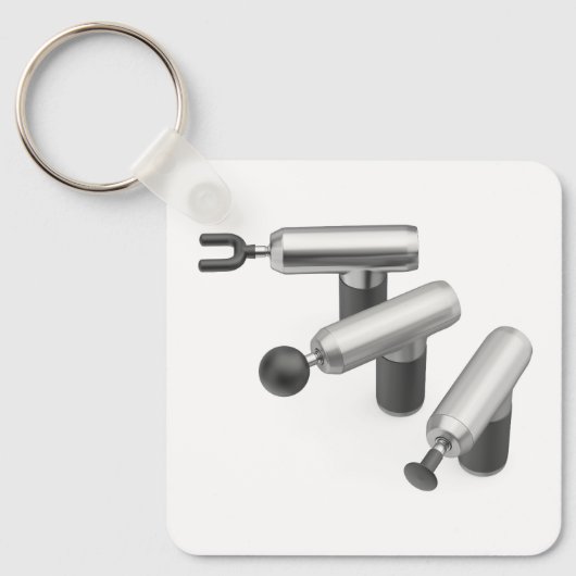 Three massage guns with different massage heads キーホルダー (正面)