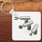 Three massage guns with different massage heads キーホルダー (正面)