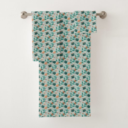 Towels with a teal floral pattern hang  バスタオルセット