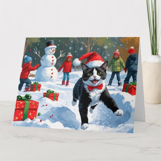 Tuxedo Cat Running in Snow with Christmas Hat カード (正面)