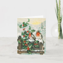 Two robins on a fence in the snow