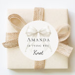 Tying the knot ivory bow pearls Bridal Shower ラウンドシール<br><div class="desc">Elevate your celebration with these chic bridal shower stickers. The design showcases a high-fidelity ivory,  cream colored bow intertwined with delicate pearl strands for a luxury finish. These labels are perfect for sealing bachelorette party invitation envelopes or adding to guest favor bags.</div>