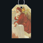Vintage Christmas ビクトリアン Santa Claus in Chimney ギフトタグ<br><div class="desc">簡単メッセージを作成するためにクリスマスギフトタグをパーソナライズするカスタムために。ヴィンテージイラストレーションビクトリアンエラメリークリスマスの休日のデザインは、クリスマスイブのおもちゃでいっぱいの袋で雪の上の屋根の登山の上にサンタクロースをフィーチャー。屋根の上に聖ニコラスとすてきとても寒い冬の夕べ。</div>