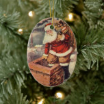 Vintage Christmas ビクトリアン Santa Claus in Chimney セラミックオーナメント<br><div class="desc">ヴィンテージのイラストレーションビクトリアンメリークリスマスの休日の画像すてきは、クリスマス・イブに玩具の袋でいっぱいの家の煙突の下に白い髭と帽子の登山を持つ古いサンタ・クロースを特徴とする。ハッピーホリデーと季節のご挨拶！</div>