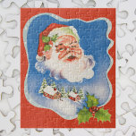 Vintage Christmas, Retro Jolly Santa Claus ジグソーパズル<br><div class="desc">Vintage illustration Christmas holiday design featuring a floating Santa Claus face over a snow covered village. Ribbon with stars and Christmas holly frame the scene.</div>