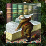 Vintage Christmas, Santa Claus いけな Nice List ポスター<br><div class="desc">ヴィンテージイラストレーションメリークリスマスの休日デザインは、本サンタクロースと彼の作品のページをフィーチャー。1889年マクラーリン・ブラザーズ発行。この物語は、世界中の良い小さな男の子や女の子のための玩具を作るサンタの仕事を物語っている。このビクトリアン時代の写真は彼のすてき図書館を通し読て、子供の名前と素敵なリストを持つ大きな本の古いサンいけなニコラスの姿を示している。</div>