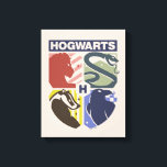 Vintage HOGWARTS™ Stamped Crest キャンバスプリント<br><div class="desc">Show your house pride in bold, vintage-inspired style with this striking Hogwarts™ crest design. Featuring graphic silhouettes representing the four iconic houses — Gryffindor™, Slytherin™, Hufflepuff™, and Ravenclaw™ — this artwork blends classic symbolism with a modern, retro aesthetic. Each house emblem is set within a clean, color-blocked shield, creating a...</div>