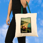 Vintage Travel, Amalfi Italian Coast Beach トートバッグ<br><div class="desc">Vintage illustration European travel poster or luggage label from the Amalfi coast in Italy featuring the beautiful blue Mediterranean Sea,  the famous steep cliffs of Amalfi and some red geranium flowers in the foreground. Text reads Amalfi Italia.</div>