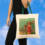 Vintage Travel, Atlantic City Resort Beach Blonde トートバッグ<br><div class="desc">Vintage illustration United States of America travel poster or luggage label for Atlantic City, New Jersey via the Pennsylvania railroad featuring a beautiful blond pin up woman in a bathing suit holding a towel looking up at the sun on the beach during the summer. People are having fun on the...</div>