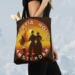 Vintage Travel, Victoria Hotel, Amsterdam, Holland トートバッグ<br><div class="desc">Vintage illustration European travel poster or luggage label from the Victoria Hotel,  Amsterdam,  Holland (the Netherlands) featuring a man and a woman in traditional dress and wearing clogs. A windmill,  sailboat on the ocean and a yellow sunset are in the background behind a silhouette of a happy couple.</div>