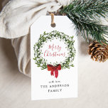 Watercolor Snowberry Greenery Wreath Holiday ギフトタグ<br><div class="desc">Elegant, holiday gift tags featuring "Merry Christmas" in a red calligraphy script encircled by a wreath of snowberries and greenery with a red bow at the bottom. Personalize the festive holiday gift tags by adding a custom greeting and your name. The holiday gift tag reverses to a solid red background....</div>
