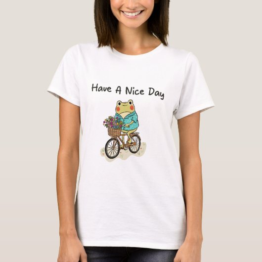 Whimsical Frog Riding A Bike Illustration Tシャツ (正面)