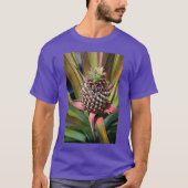 Young pineapple growing under the tropical sun tシャツ (正面)